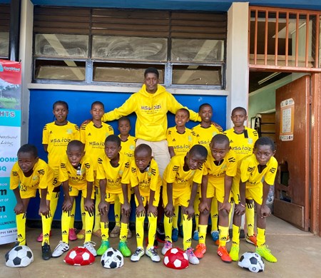Pius Mithika and the youth soccer team he mentors.